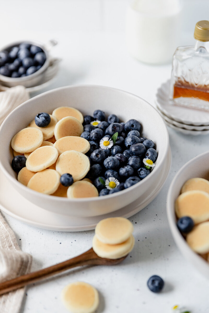 mini pancakes and blueberries in a bowl