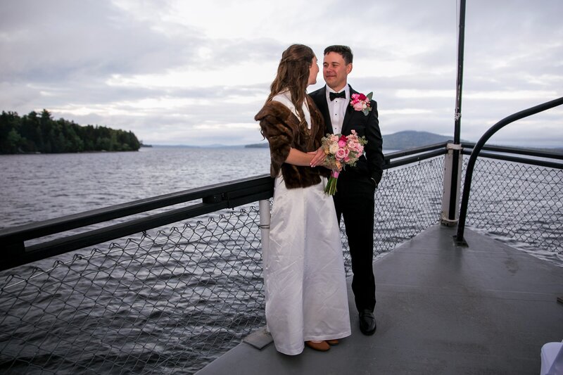 Bride and Groom standing at front of boat looking at each other | Wedding Photography