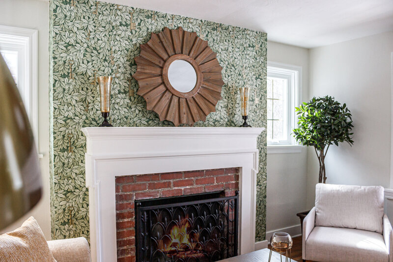 Professionally staged fireplace with green wallpaper surrounding designed to maximize home value and buyer appeal