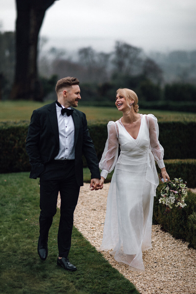 A wedding photographer captures the magical moment of a bride and groom celebrating their wedding ceremony as the bride throws the bouquet in the air