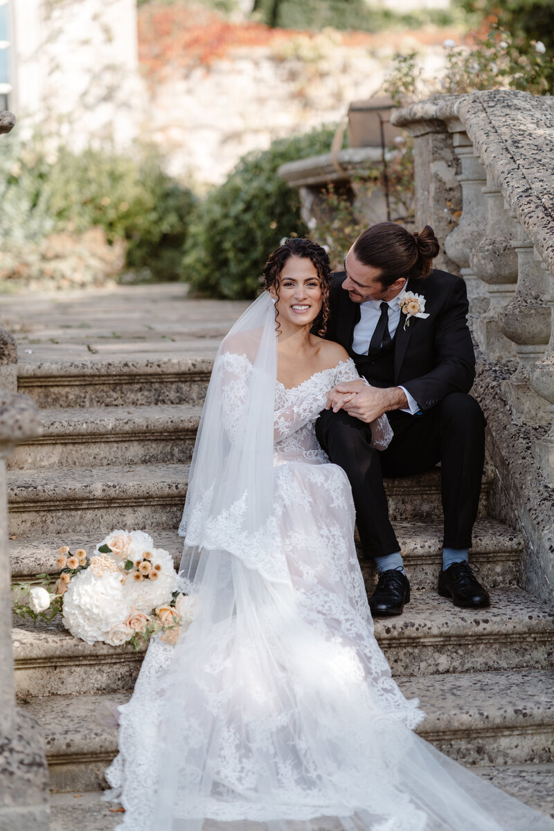 Bride and Groom sat on steps at euridge manor - luxury wedding photography