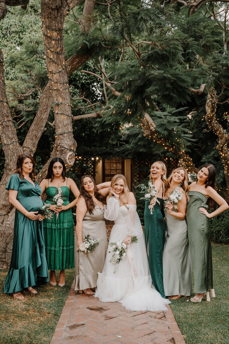 bride standing with bridesmaids