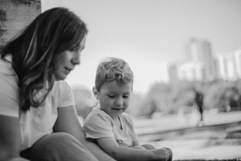 Candid, naturally posed family portrait of parents and small children snuggling