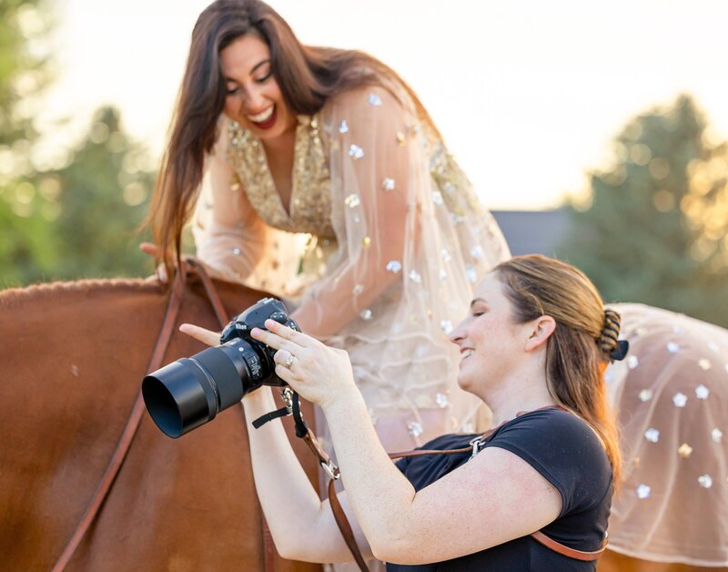 Horse Photographer rachel griffin shows a portrait client a preview image on the back of her camera