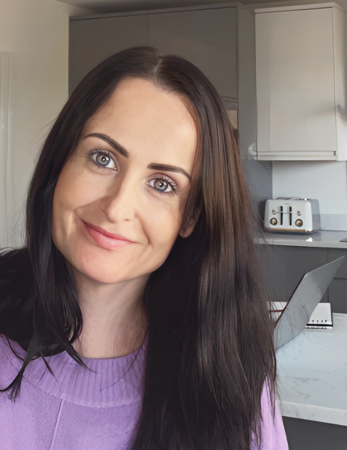 Close-up image of Teresa Quinn, owner of The Purple Flamingo, in a purple jumper, representing her personal connection and dedication to her clients.