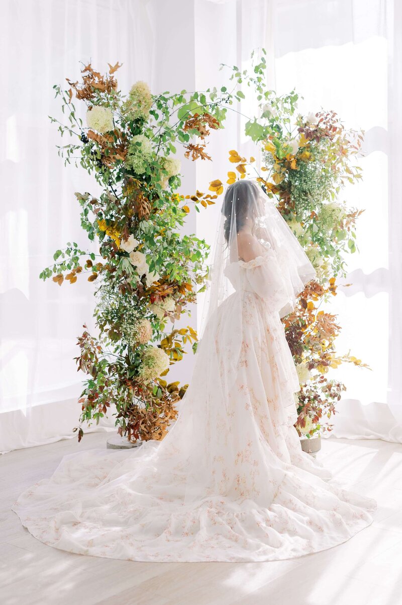 Bride in front of Large Whimsical Arch