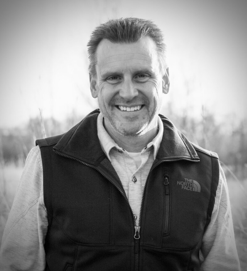 Lon Stroschein smiling outdoors in a fleece vest, inviting future members to join the Vintage One waitlist