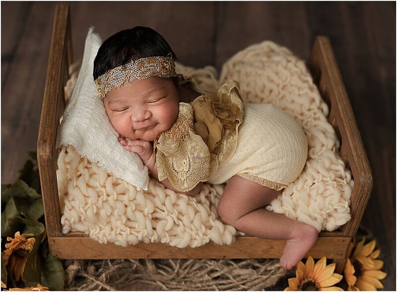 baby girl on cream backdrop with mom hand caressing her face