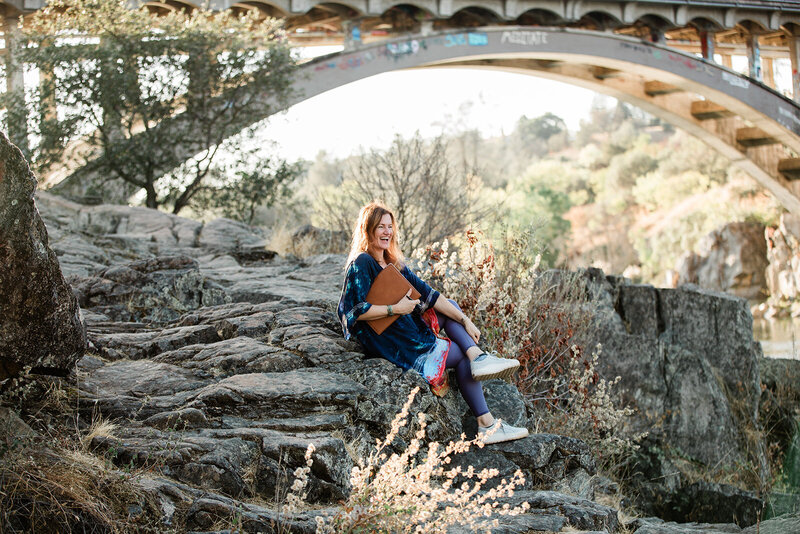 woman on rock smiling