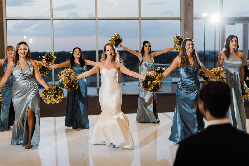 bride and bridesmaids dance with pompoms