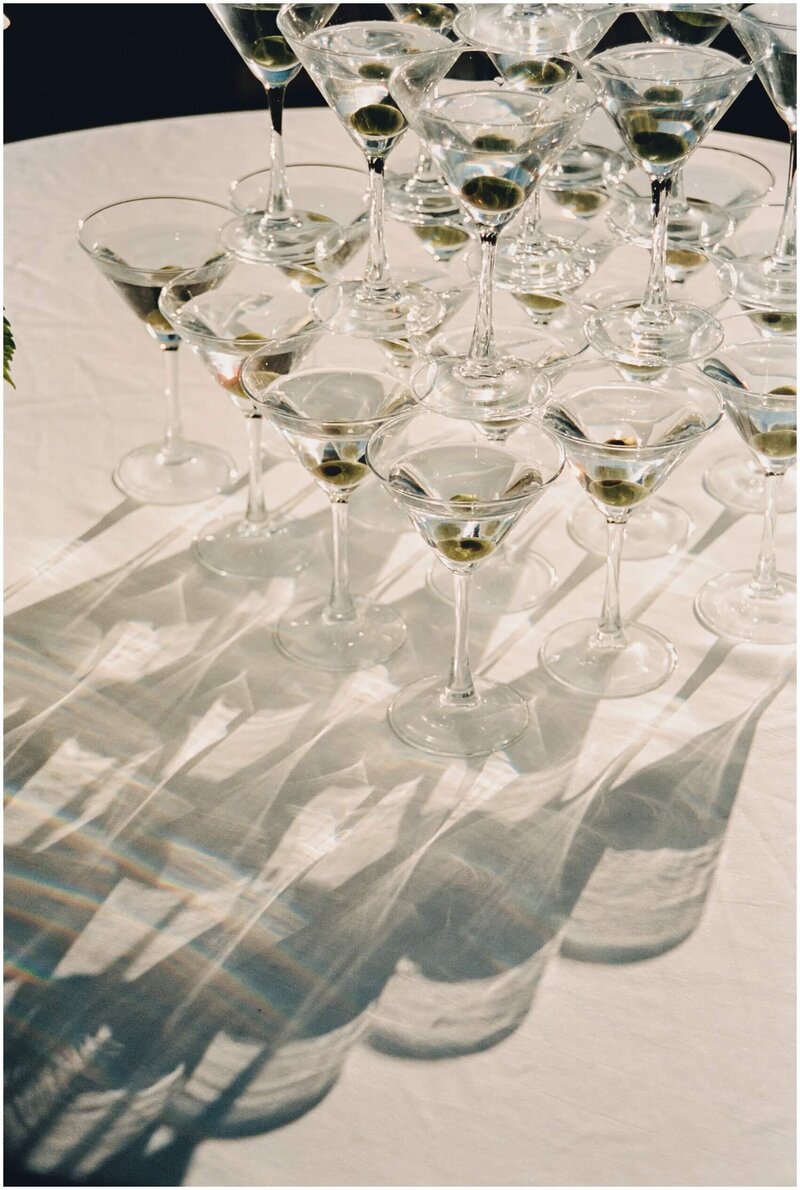 Shadows and light mingle on a table through a martini tower