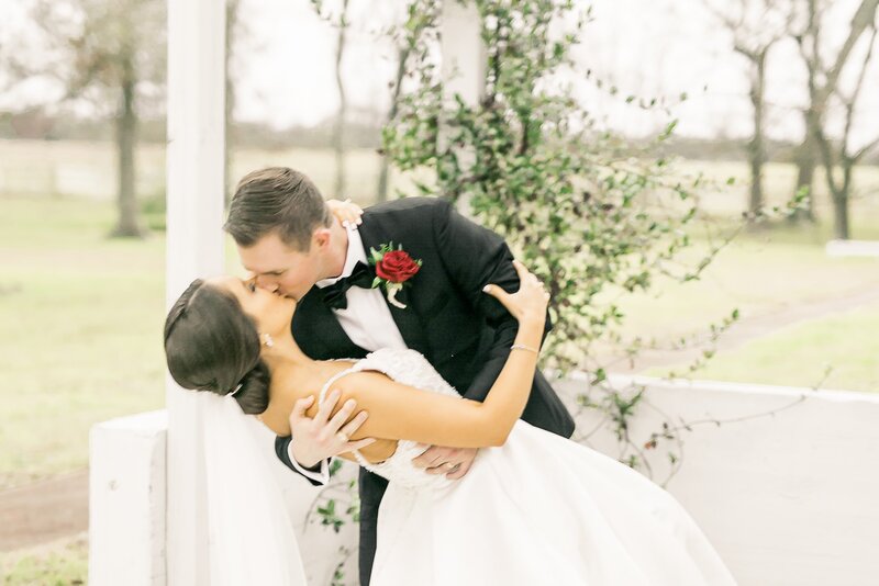 Stress-Free Zones-2_bride and groom kissing in the greenhouse pavilion_The Grand Texana Historic Venue_Houston TX (2)