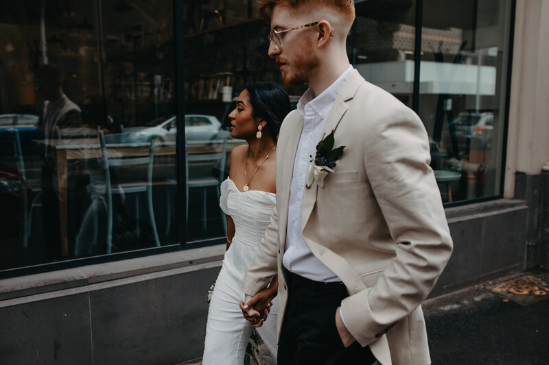 modern bride and groom walking through inner city streets of melbourne