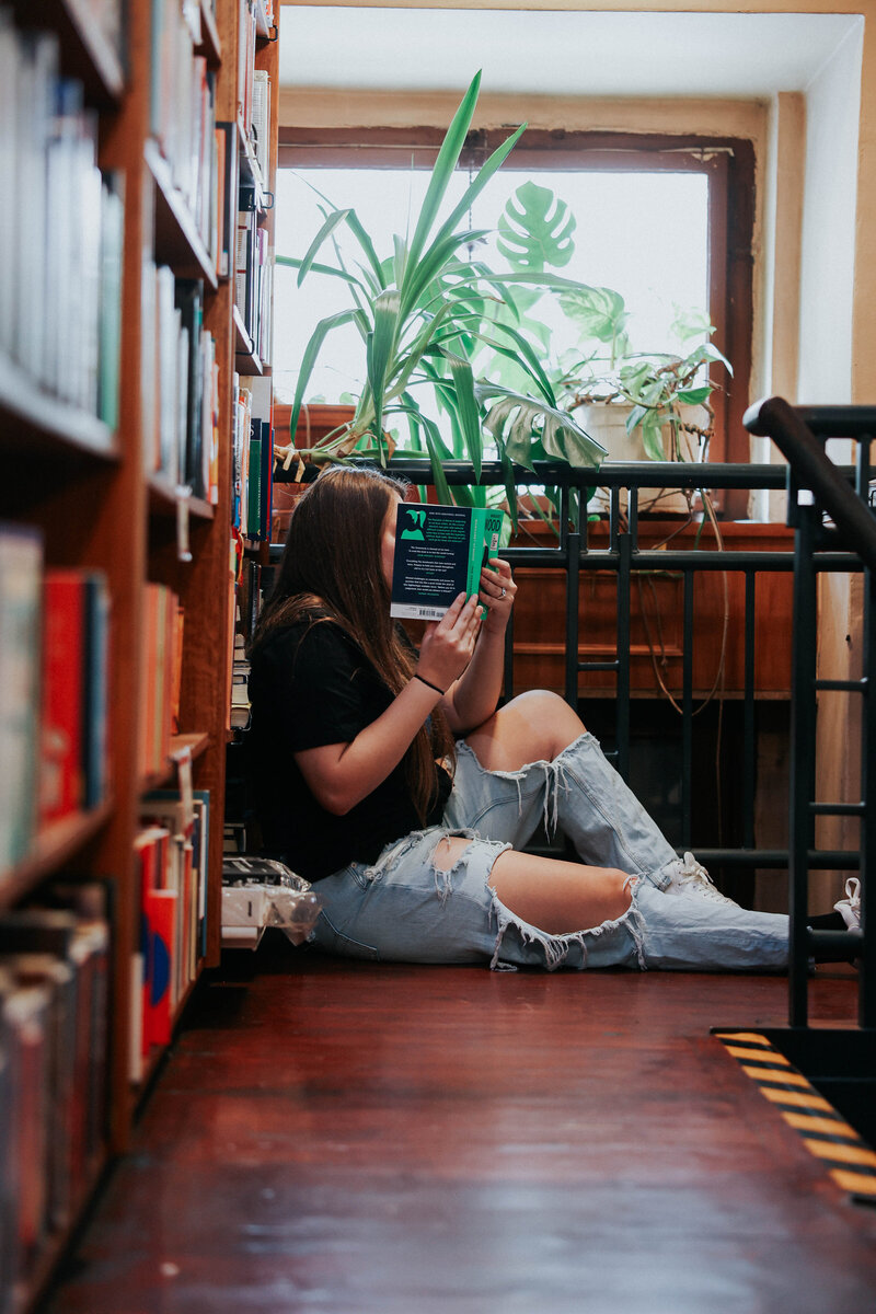 KP reads a book on the ground