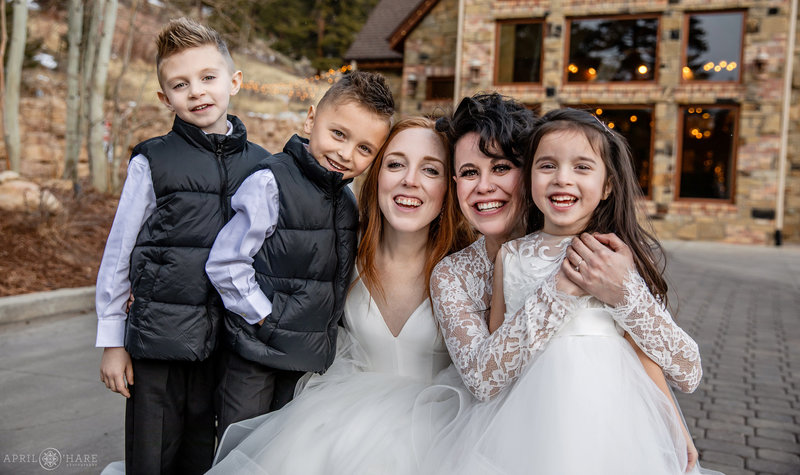 Two brides with the ringbearers and flower girl at winter Della Terra wedding