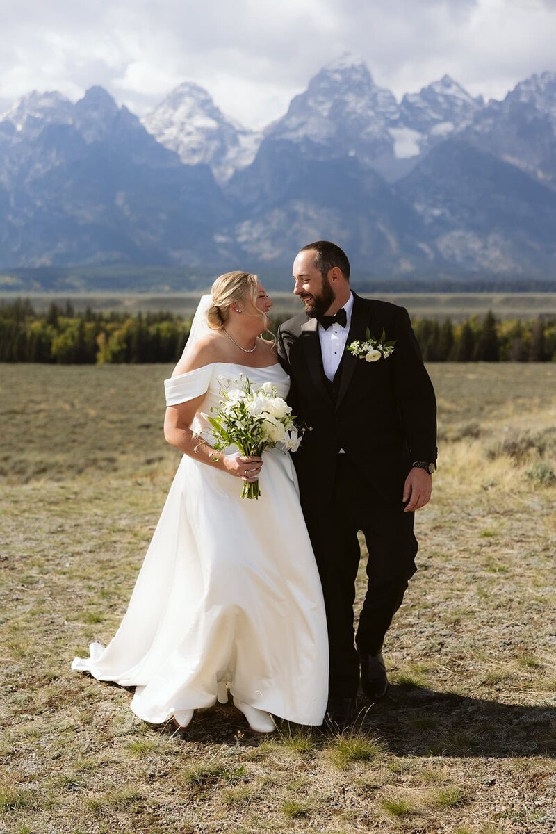 A couple looking into each others eyes laughing in the Sawtooth mountains in Stanley, Idaho