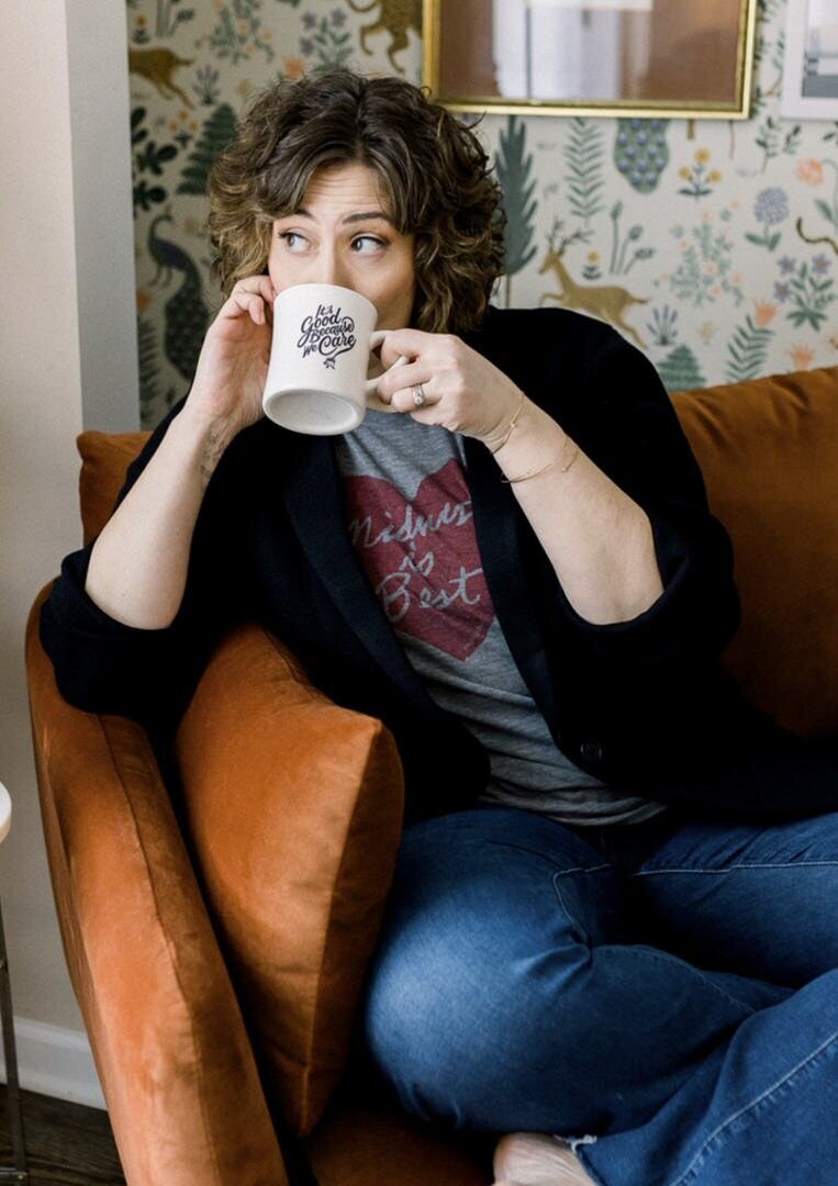 Paige Worthy with coffee mug sitting on a couch