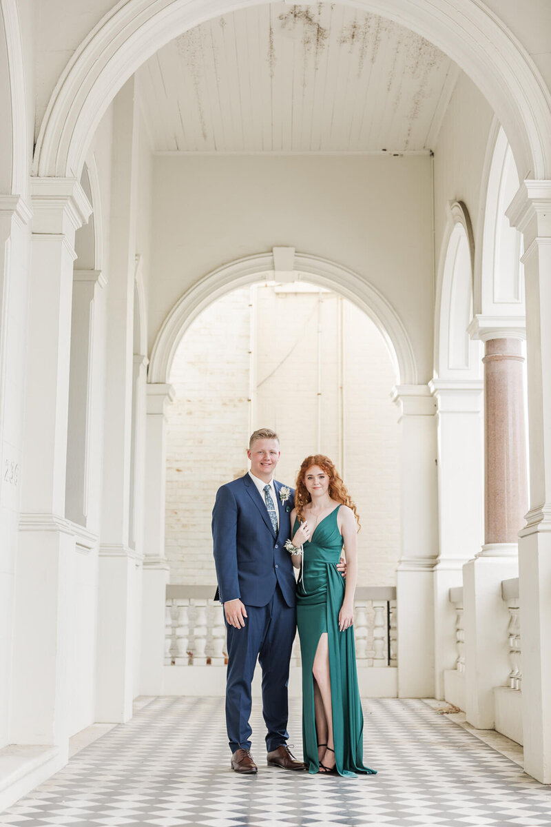 Two graduates in their formal attire standing in a beautiful heritage listed building located at Quay Street, Rockhampton.