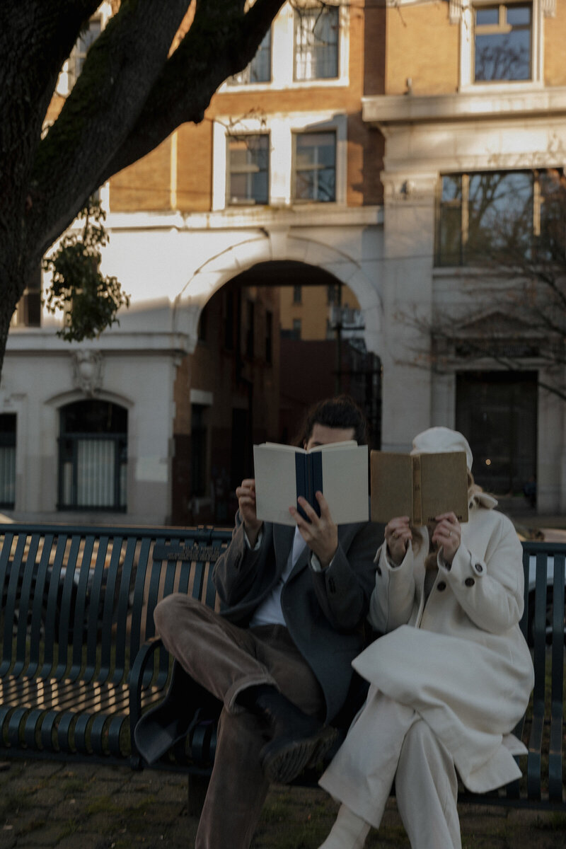 man and woman couple reading in European city