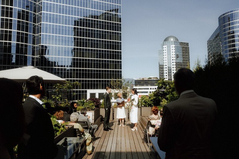 bride and groom during an outdoor wedding ceremony on the rooftop of the vancouver club