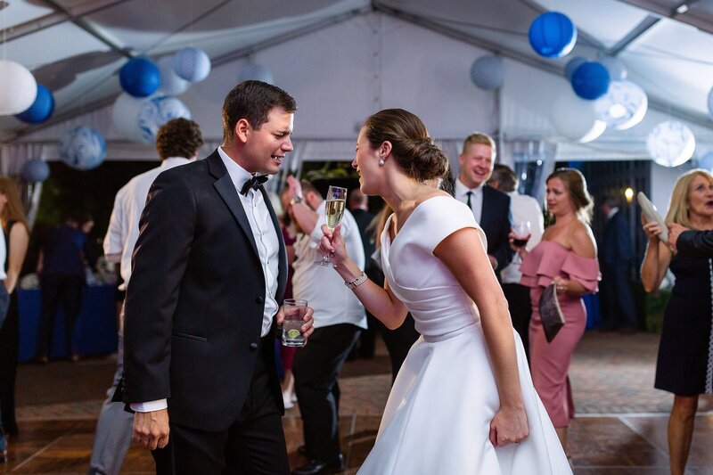modern wedding photo capturing a fun moment of bride and groom dancing and singing