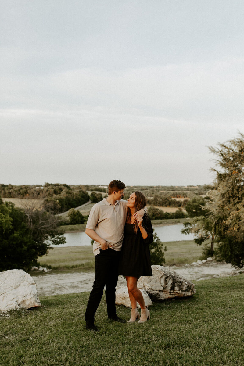 couple embracing on hillside