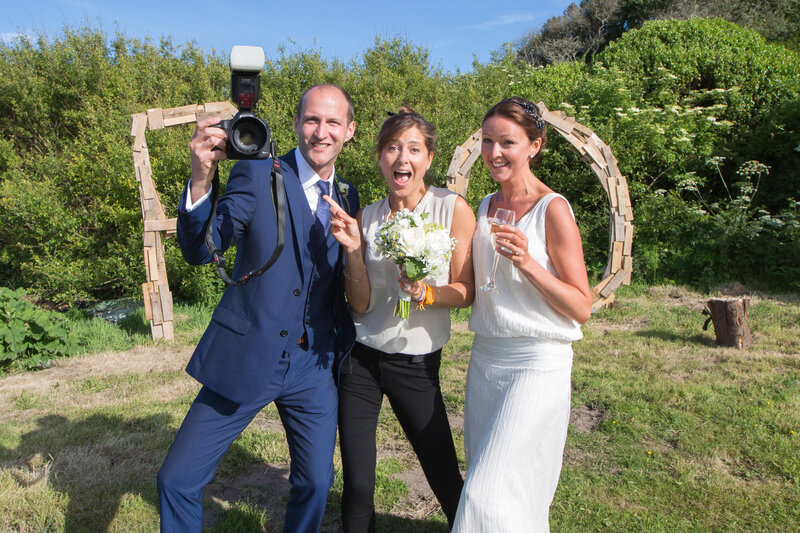 Photographers posing for picture with bride