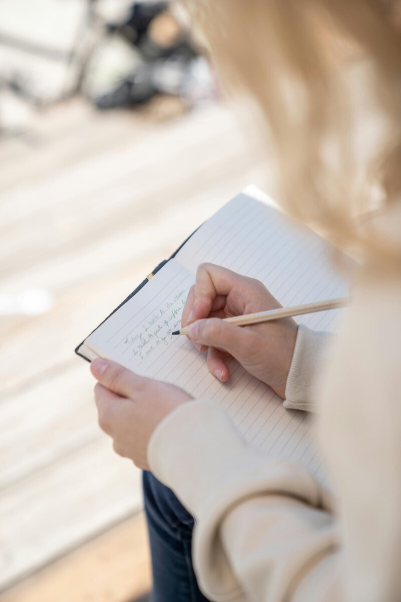 Cognitive behavioral therapy for kids featuring woman writing in notebook