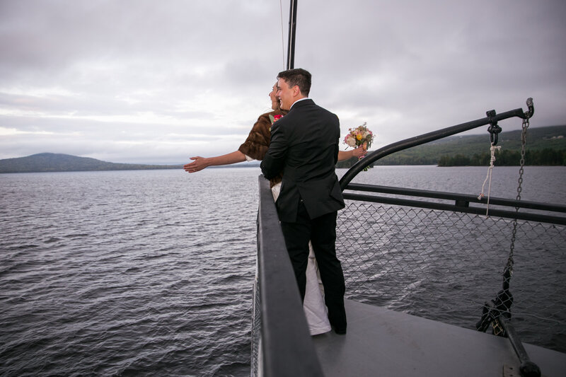 Bride and Groom doing Titanic pose at bow of boat | Wedding Photography taken by Maine Wedding Photographer