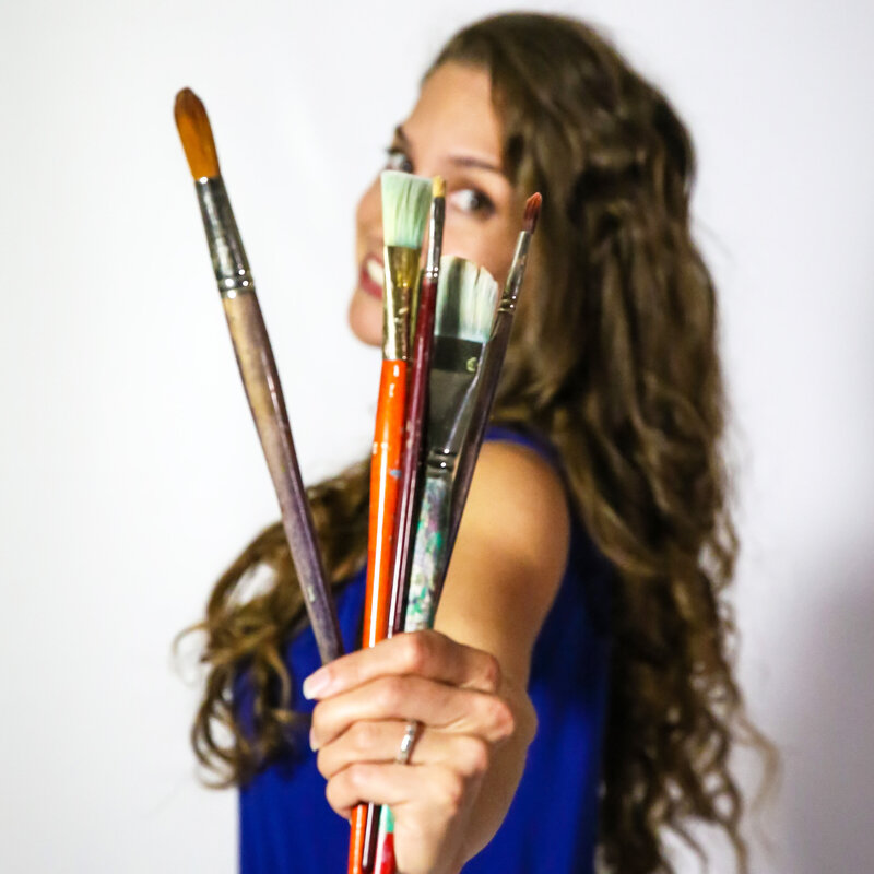 woman standing with artwork