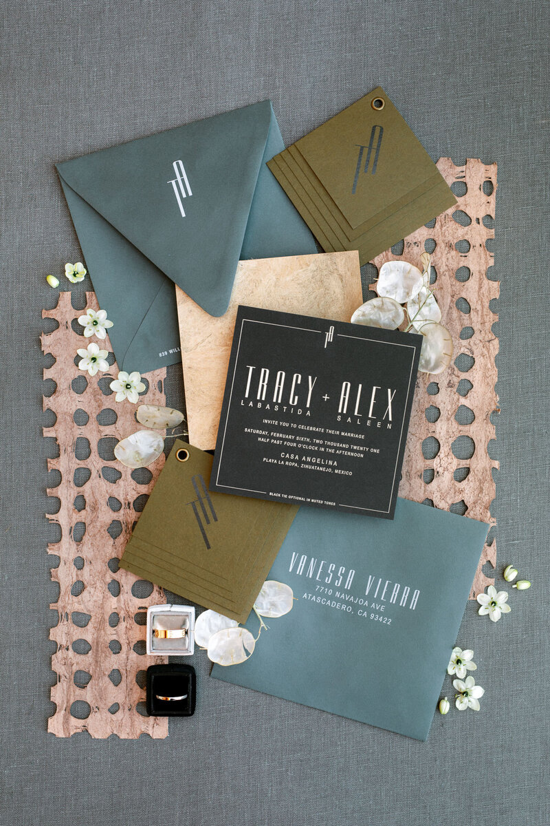Beautiful blue pink and moss colored wedding invitation suite for details flatlay