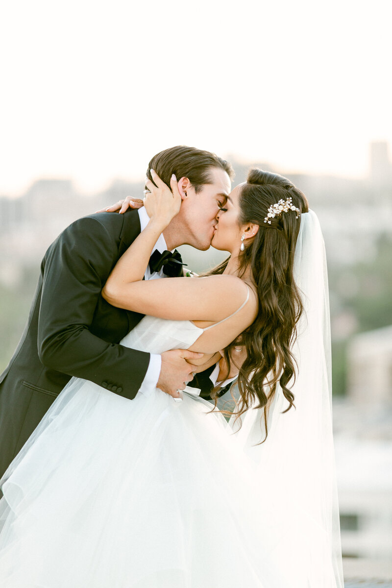 Elegant bride and groom kiss on their wedding day