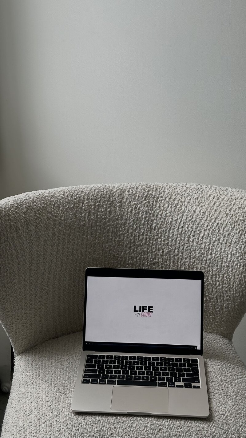 laptop opened on a chair with a website displayed