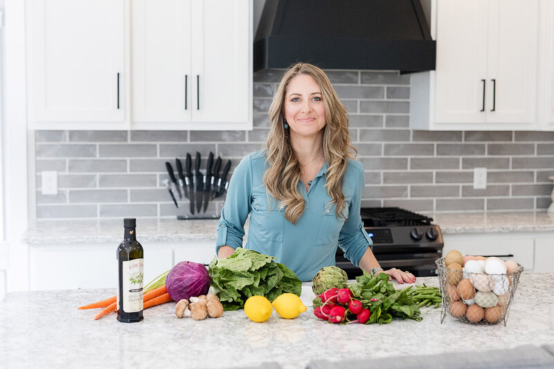 Amy in the kitchen next to healthy food