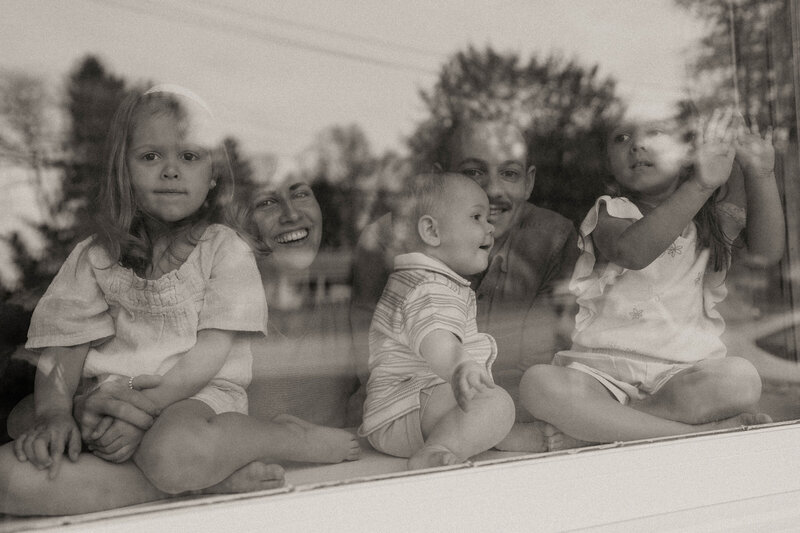 black and white family in window