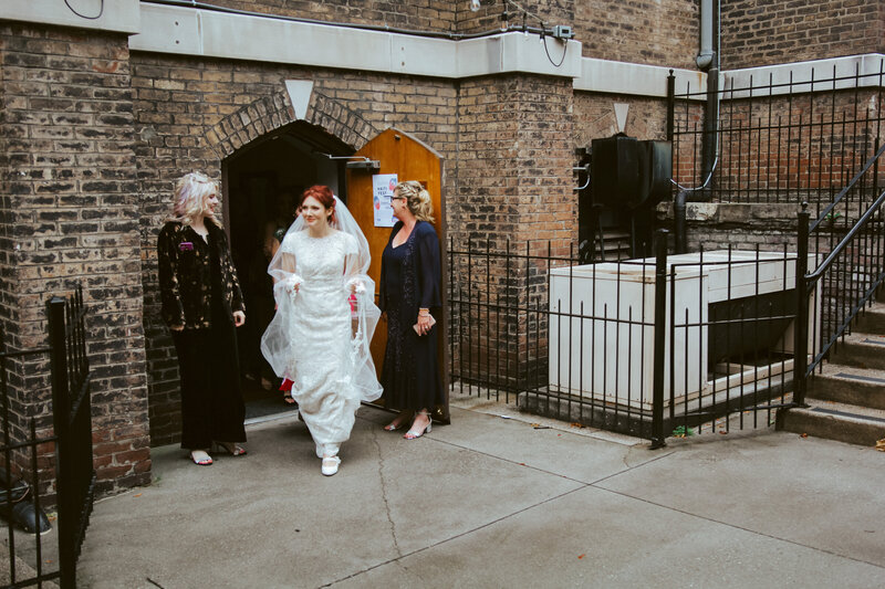 bride walking next to church