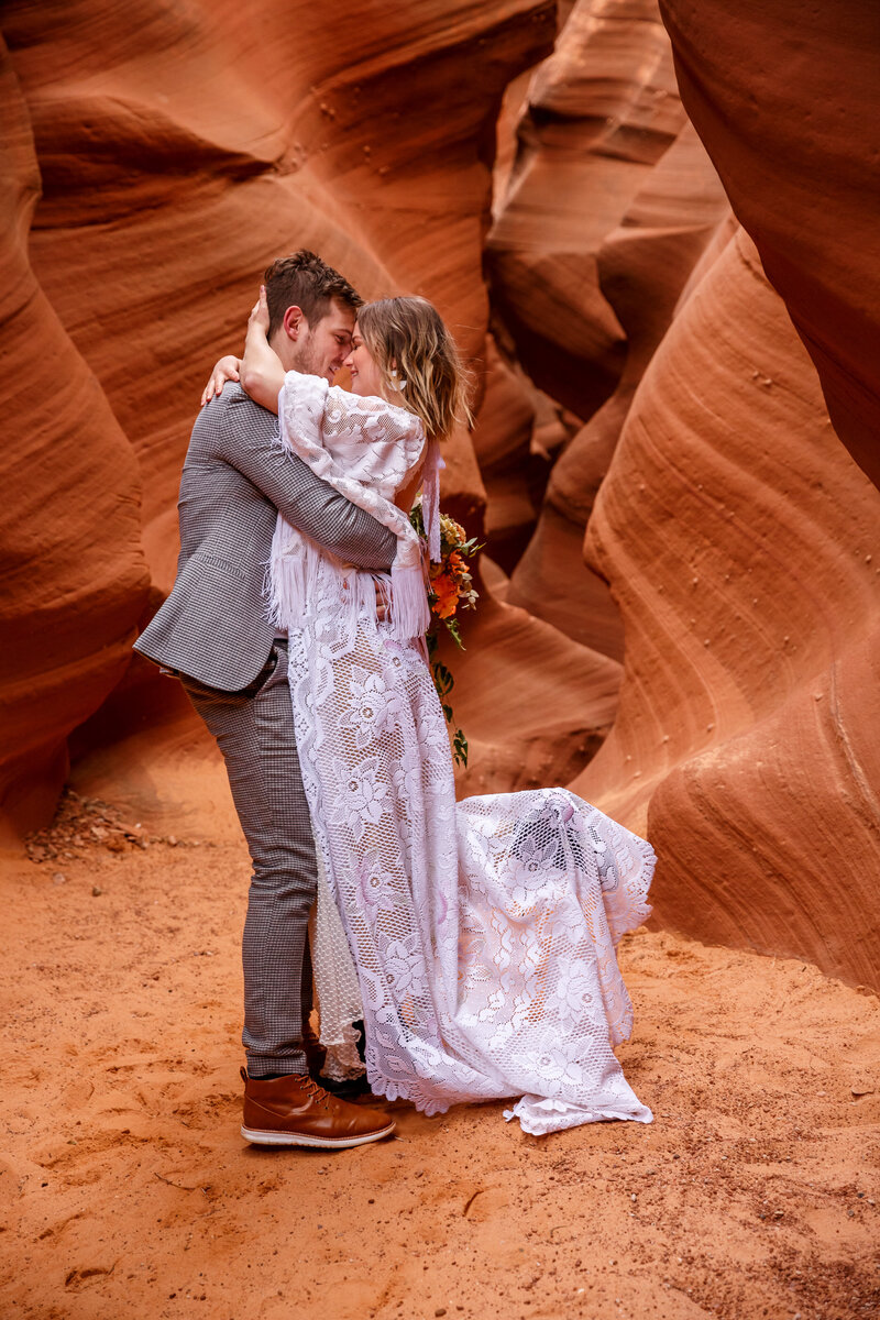 An eloping couple dances in a slot canyon at their Page, Arizona elopement.