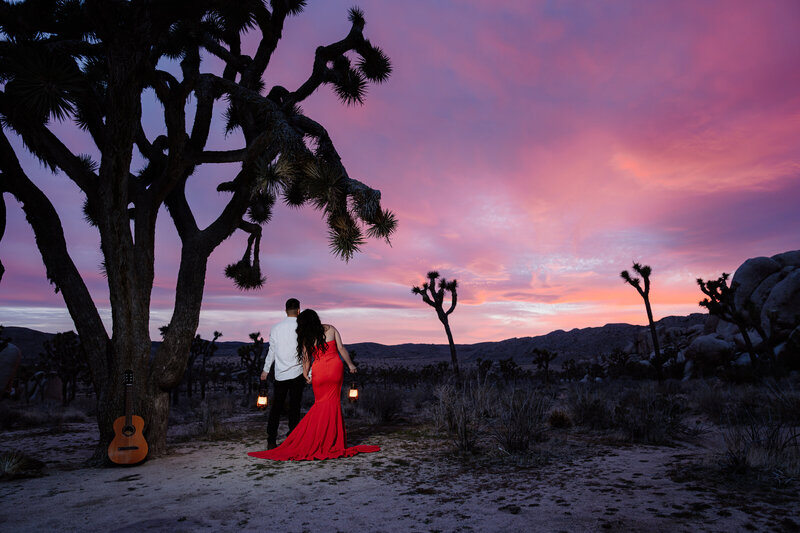 Joshua Tree Elopement with Asian couple during sunset blue hour at Hidden Valley holding lanterns.