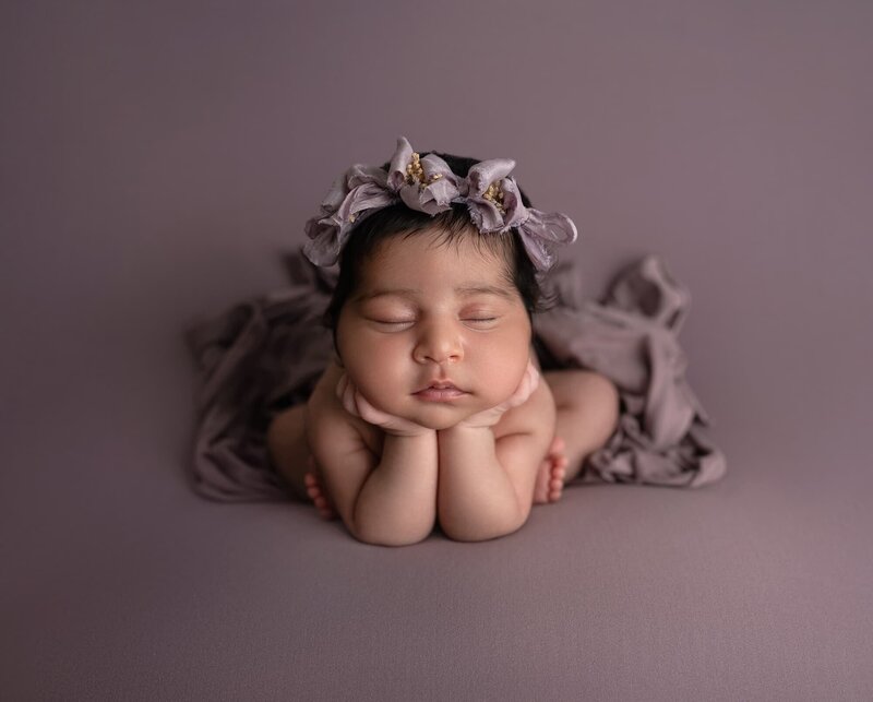 baby girl froggy pose purple blanket and purple headband