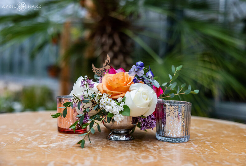 Cocktail table floral centerpiece inside the Orangery Greenhouse at Denver Botanic Gardens in Colorado