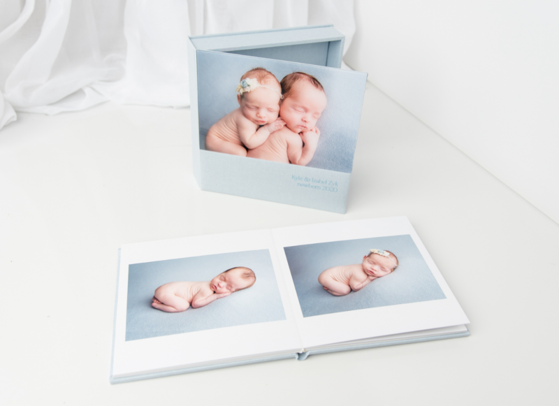 Baby blue album showing newborn photo session images