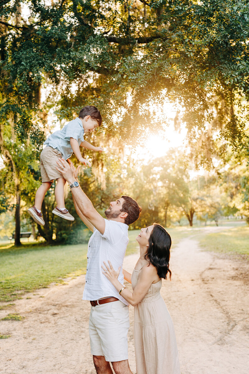 family with little boy thrown in the air during a family photography session