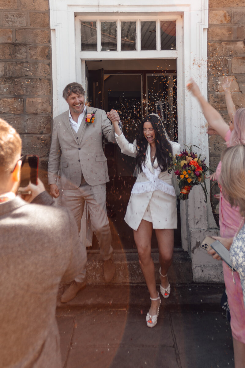 Wedding photographer captures couple taking a stroll hand in hand at their french chateau wedding.