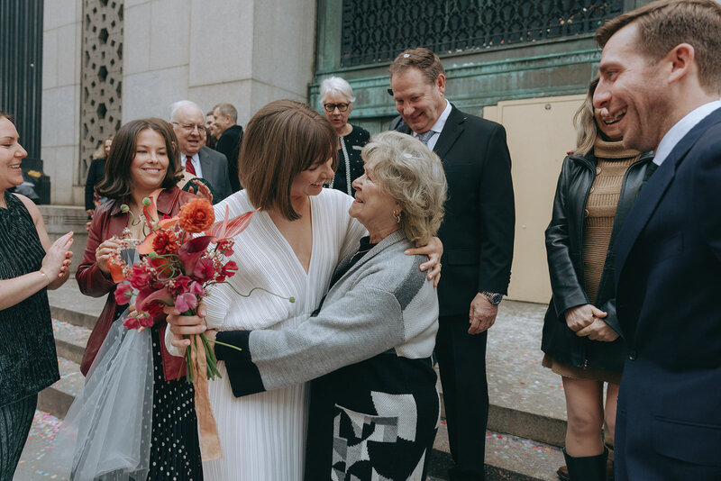 bride hugging grandma after eloping at ny city hall shot by Elsie Goodman Photography | NYC Elopement Packages