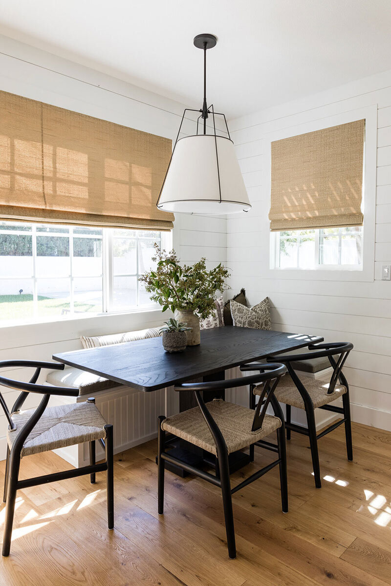 Cottage-style dining space featuring light natural materials and personalized interiors in Costa Mesa house
