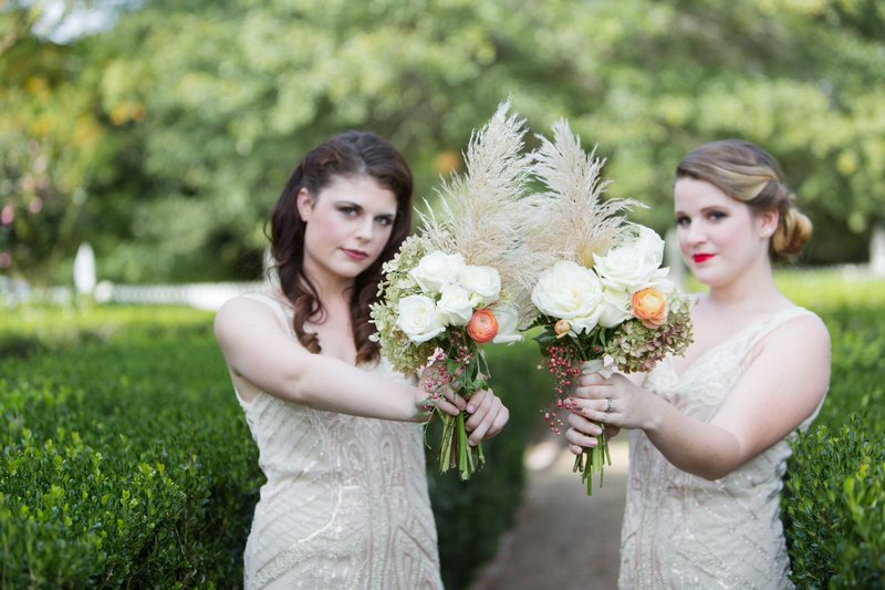 Great gatsby inspired bridesmaids hold fern bouquets