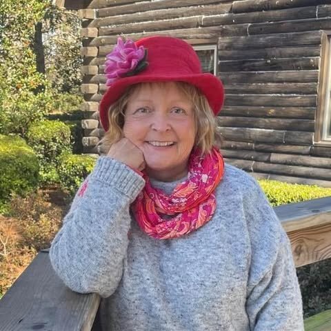 Edisto Island Vacation Rental Host, Jan Keen. She's wearing a grey sweater, pink hat, and pink knitted scarf