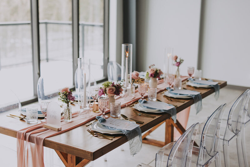 Dog wearing a floral collar sitting in the ceremony aisle, part of wedding floral services by The Gem.