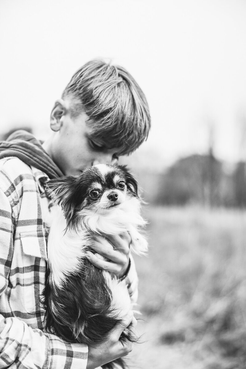 Black and white portrait of a boy and his dog. 