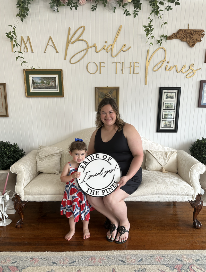 bride with her daughter saying yes to her dream wedding dress